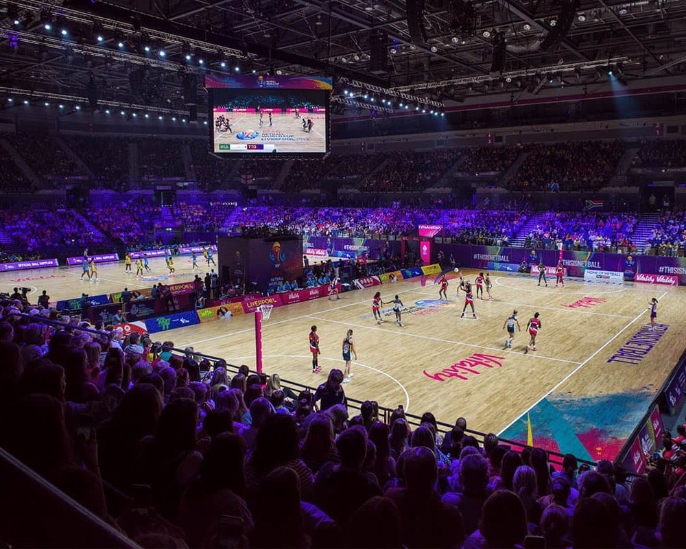 A photo of the M&S Bank Arena in Liverpool, with large crowds watching two matches take place at the Vitality Netball World Cup 2019