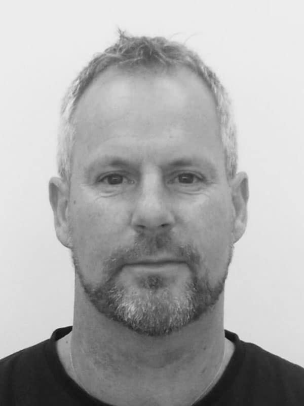 A black and white photo of Darren Hirter of Red Sky at Night Events